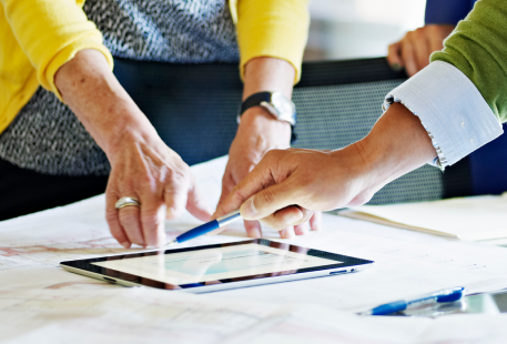 Financial plans are discussed over a tablet device. 